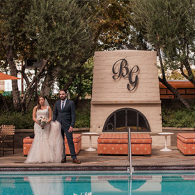 Bride and groom by pool